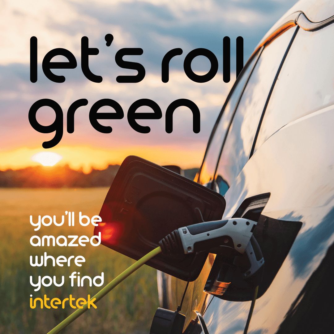 An electric vehicle charging at sunset with the text "let's roll green, you'll be amazed where you find intertek" promoting eco-friendly transportation.