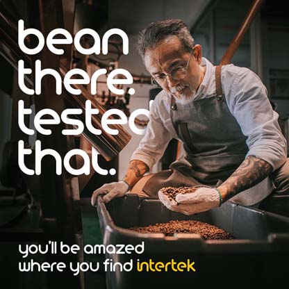 Man wearing apron examining beans in a metal container